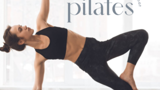 Woman in athletic wear holding a yoga pose on a mat.